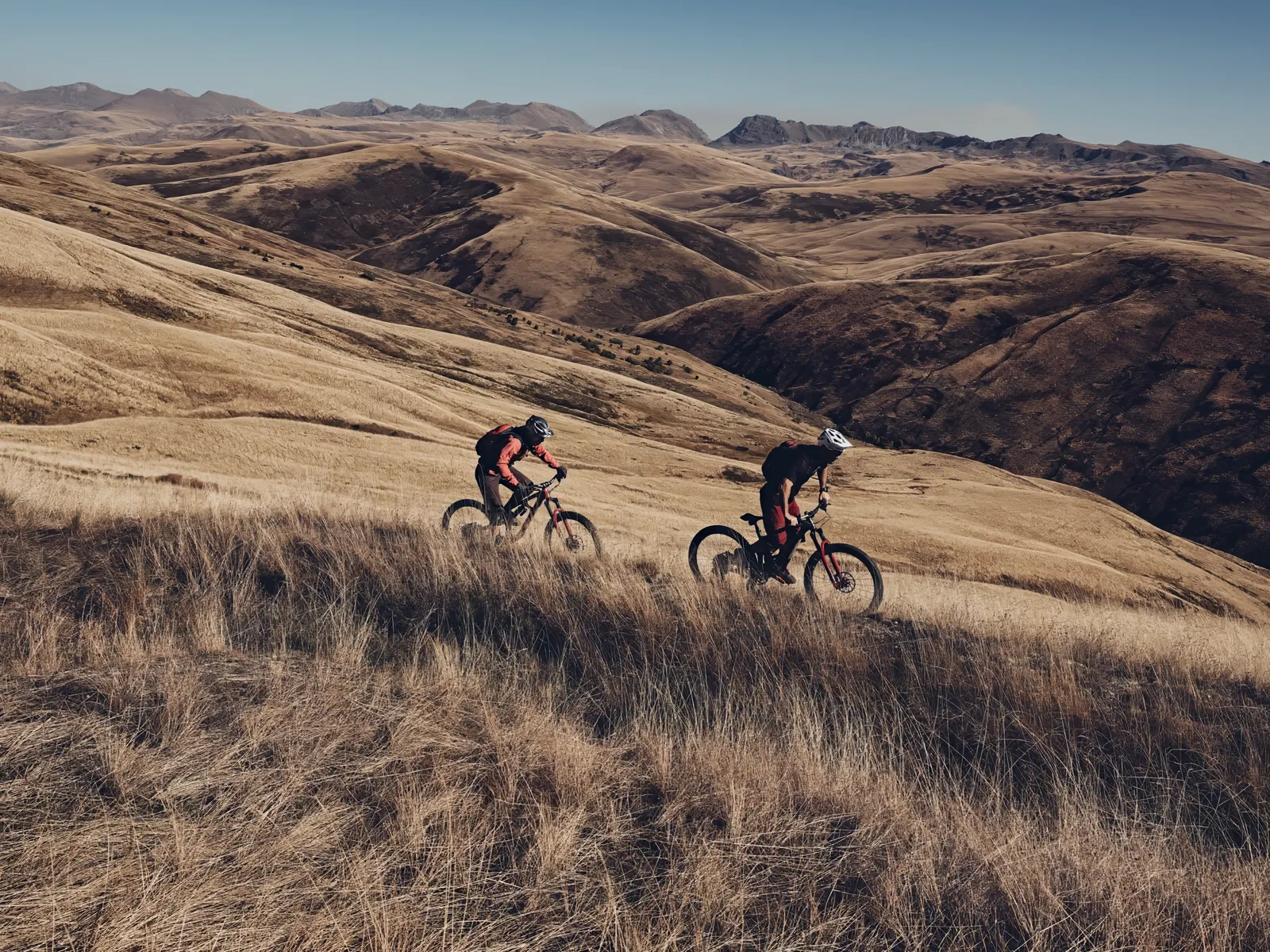 Riders climbing a gravel road in the Albanian mountains
