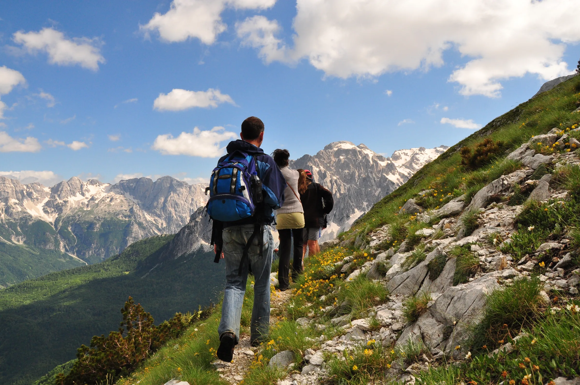 Walkers on a mountain path above the Valbona valley