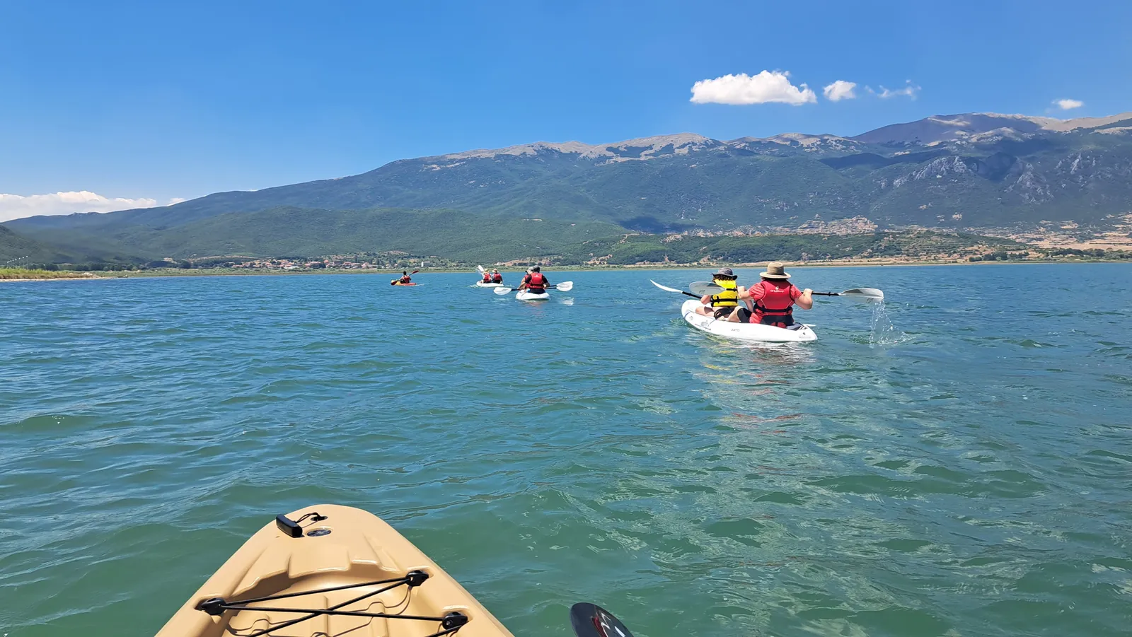 Looking forward from a kayak towards the group on the water